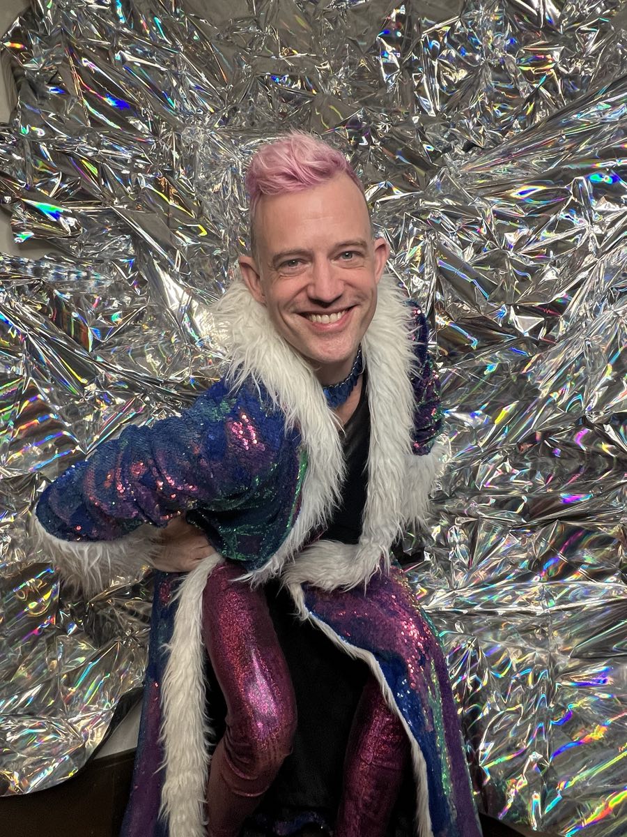 Danamor in front of a holographic foil backdrop